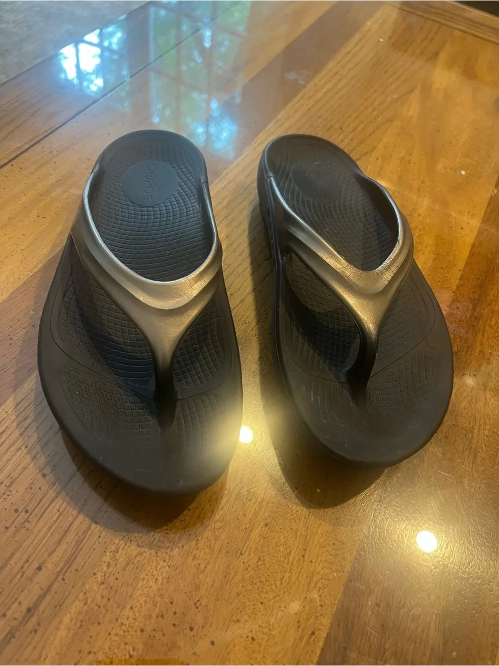 OOFOS Women's Black Flip Sandals with Metallic Silver Straps
